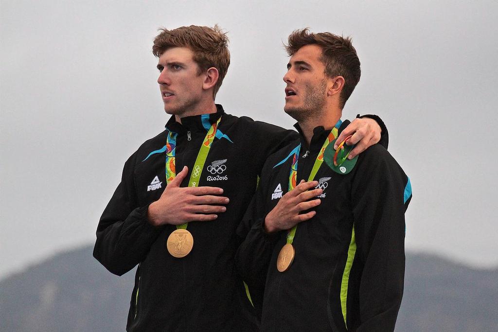 Peter Burling and Blair Tuke watch the NZ Ensign raised at the 49er Olympic Medal presentation - 2016 Sailing Olympics © Richard Gladwell www.photosport.co.nz